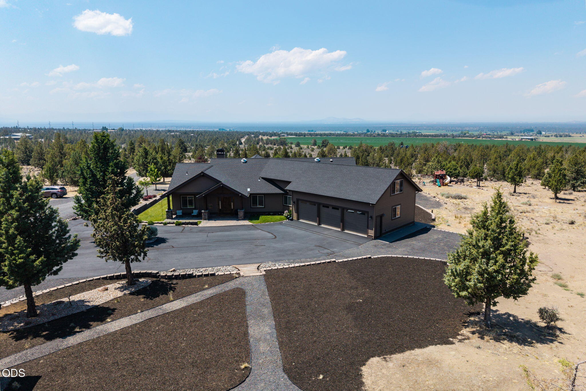 13601 Southwest Harrison Way Powell Butte, OR 97753 - Photo 74 of 81 an aerial view of a house with a yard and lake view