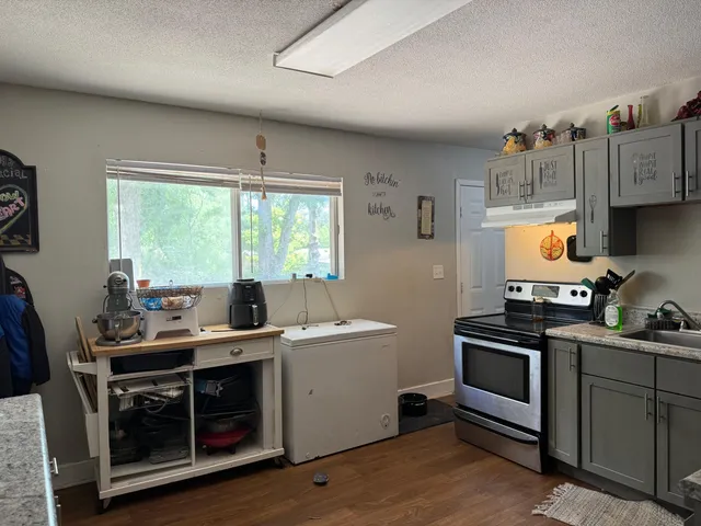 a kitchen with a stove and a sink