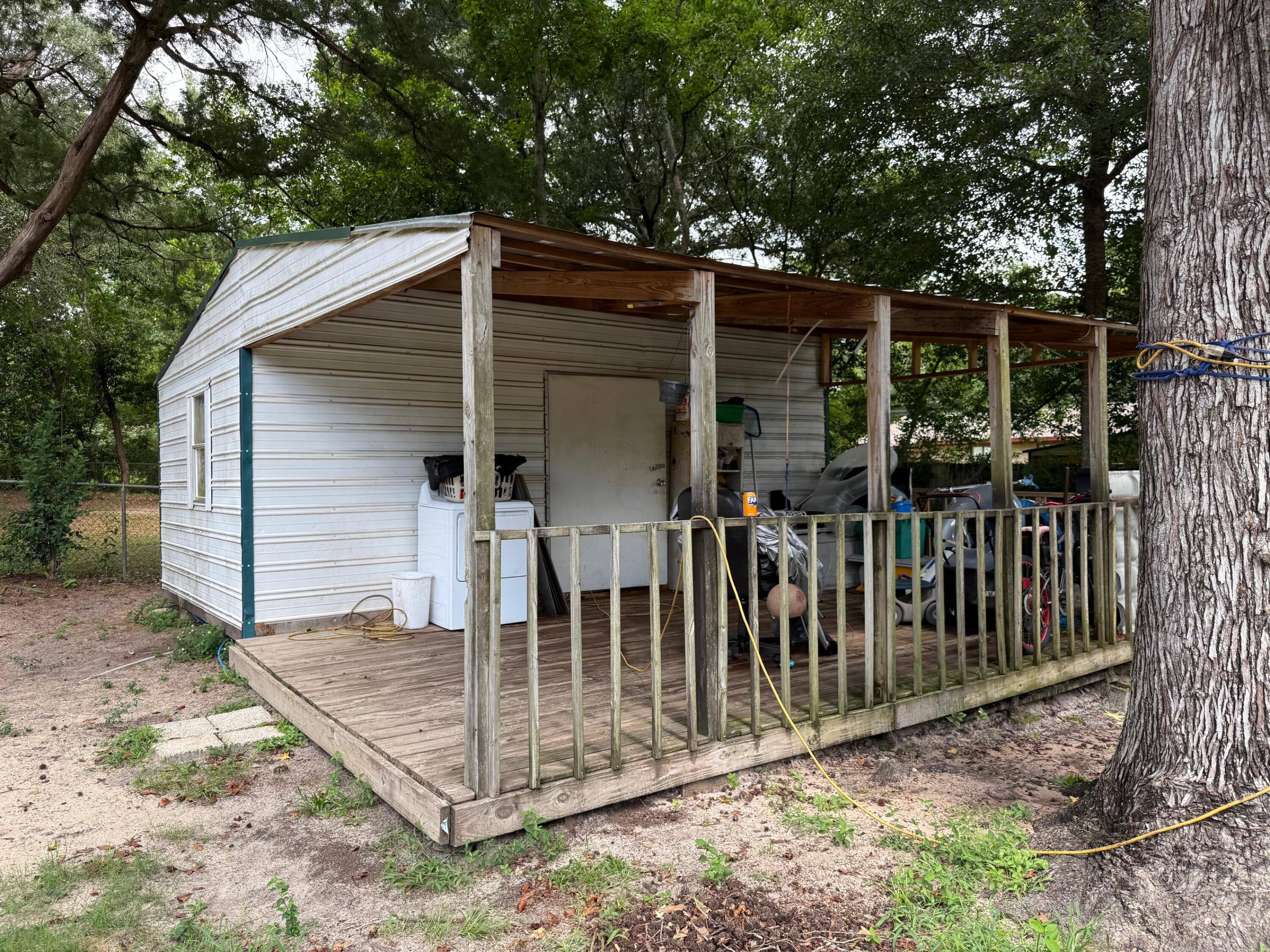 508 Forrest Court Crestview, FL 32539 - Photo 5 of 5 a view of wooden house with a small yard and large tree