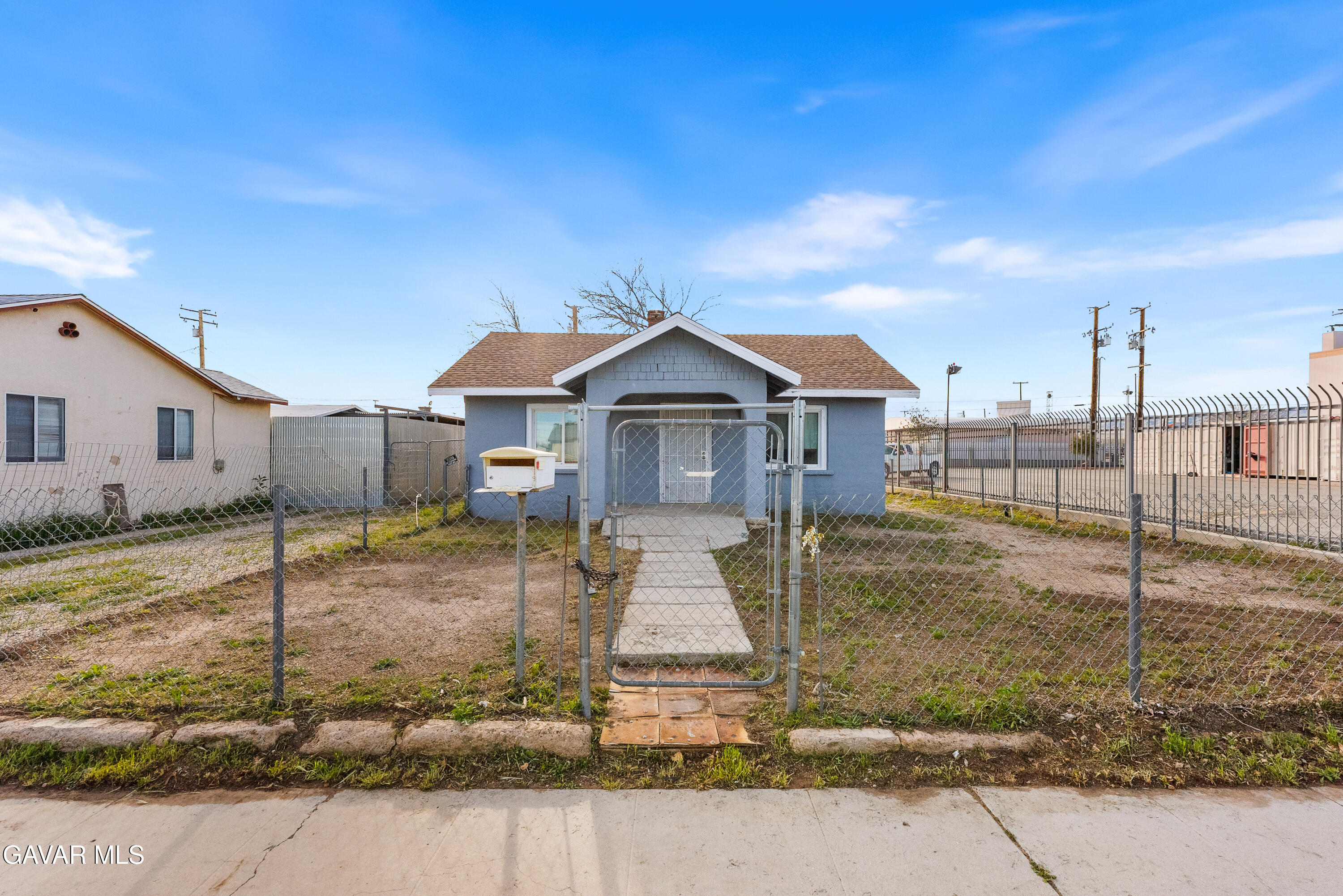 15733 K Street Mojave, CA 93501 - Photo 1 of 38 a front view of a house with garden