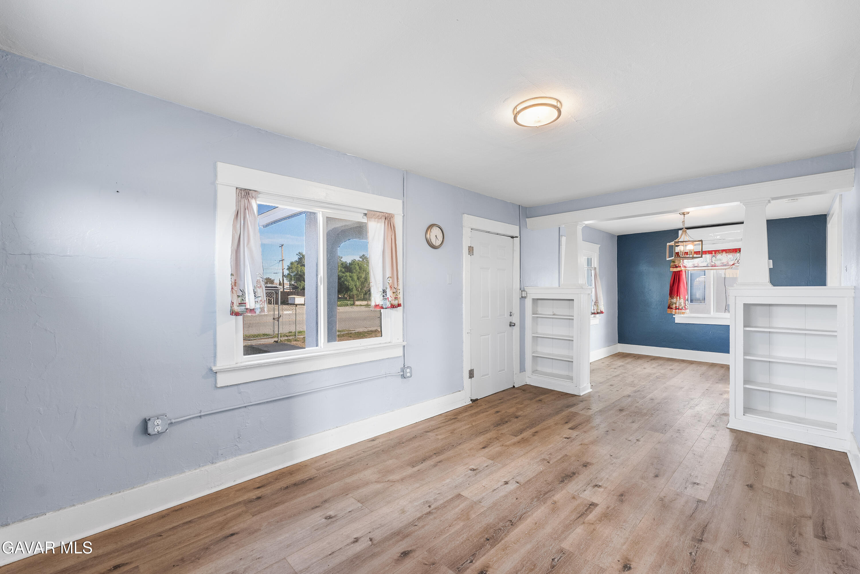15733 K Street Mojave, CA 93501 - Photo 12 of 38 an empty room with wooden floor and windows