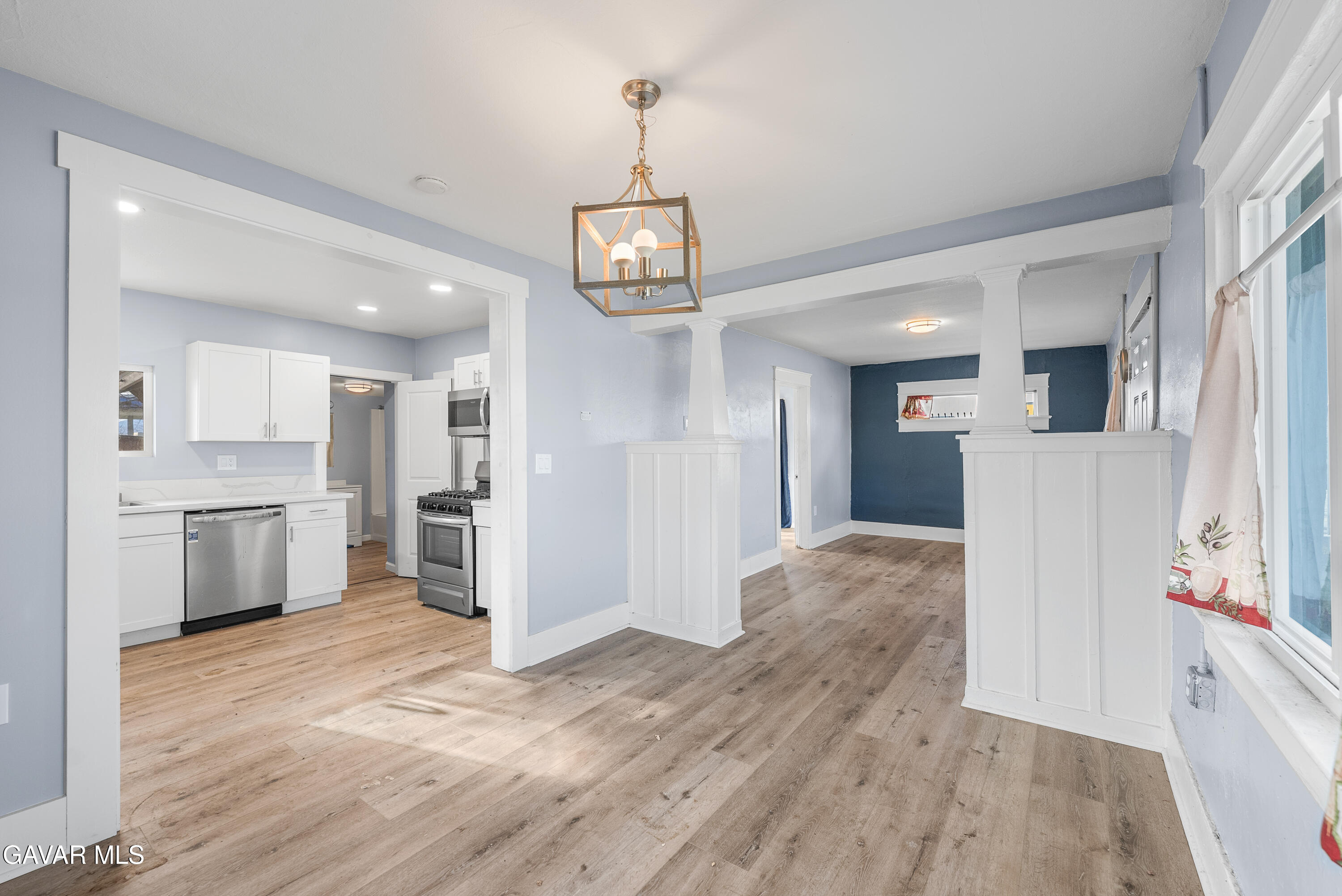 15733 K Street Mojave, CA 93501 - Photo 15 of 38 a view of a kitchen with refrigerator and wooden floor