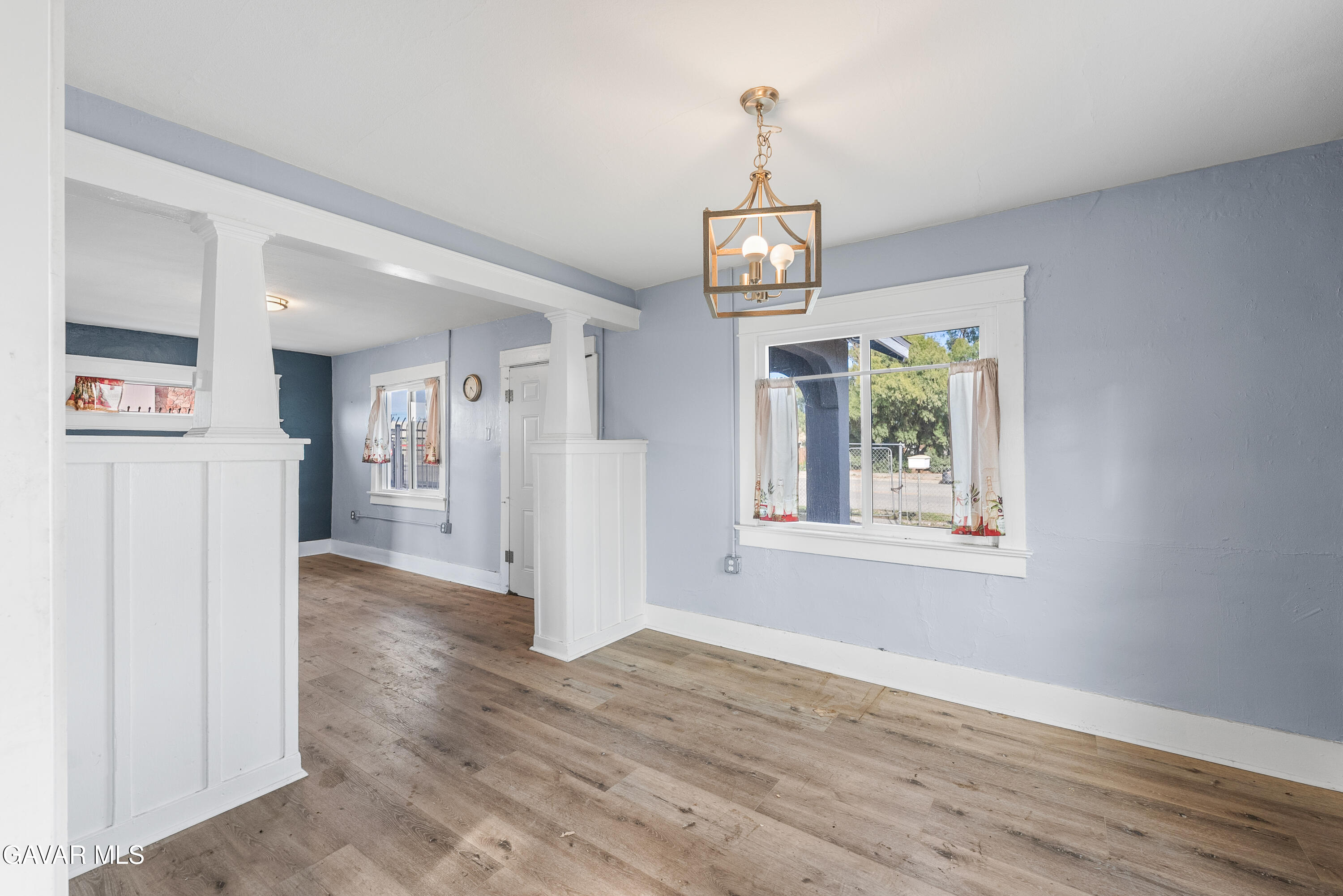 15733 K Street Mojave, CA 93501 - Photo 17 of 38 a view of a hallway with wooden floor and chandelier