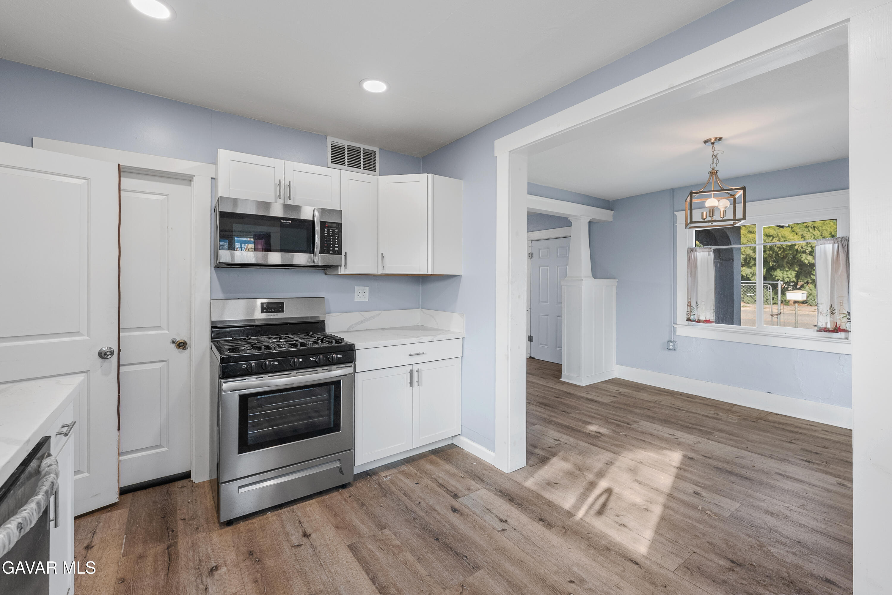 15733 K Street Mojave, CA 93501 - Photo 22 of 38 a kitchen with stainless steel appliances a stove a sink and a refrigerator