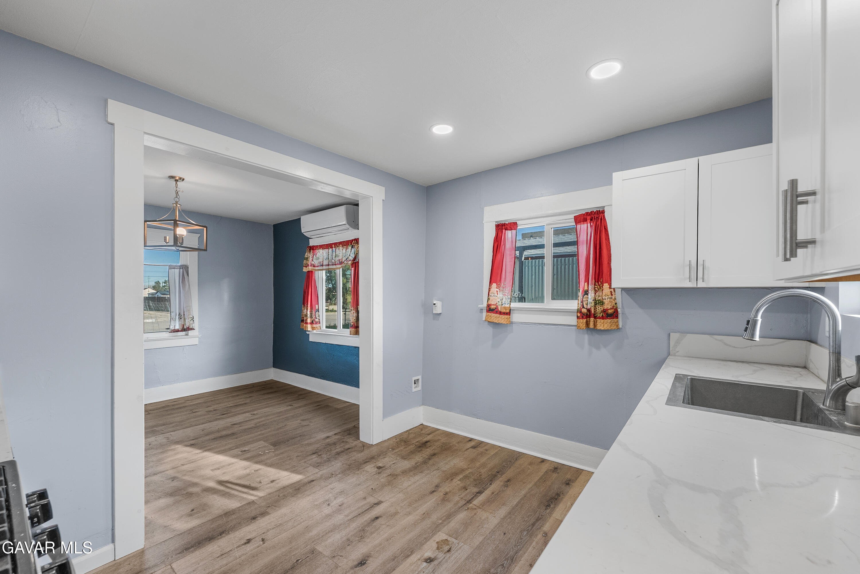 15733 K Street Mojave, CA 93501 - Photo 23 of 38 a kitchen with granite countertop a sink cabinets and wooden floor