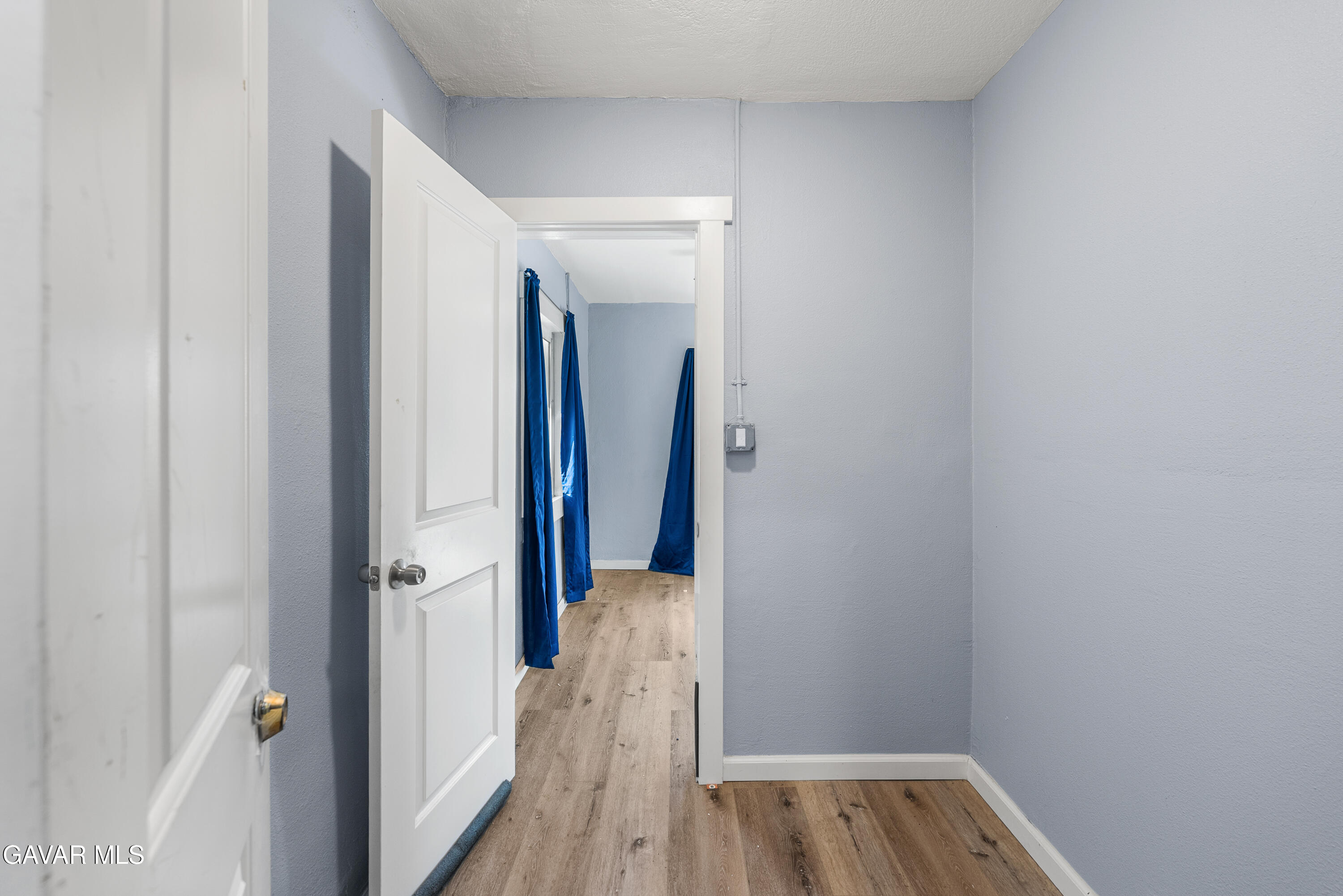 15733 K Street Mojave, CA 93501 - Photo 28 of 38 a view of a hallway with wooden floor and closet