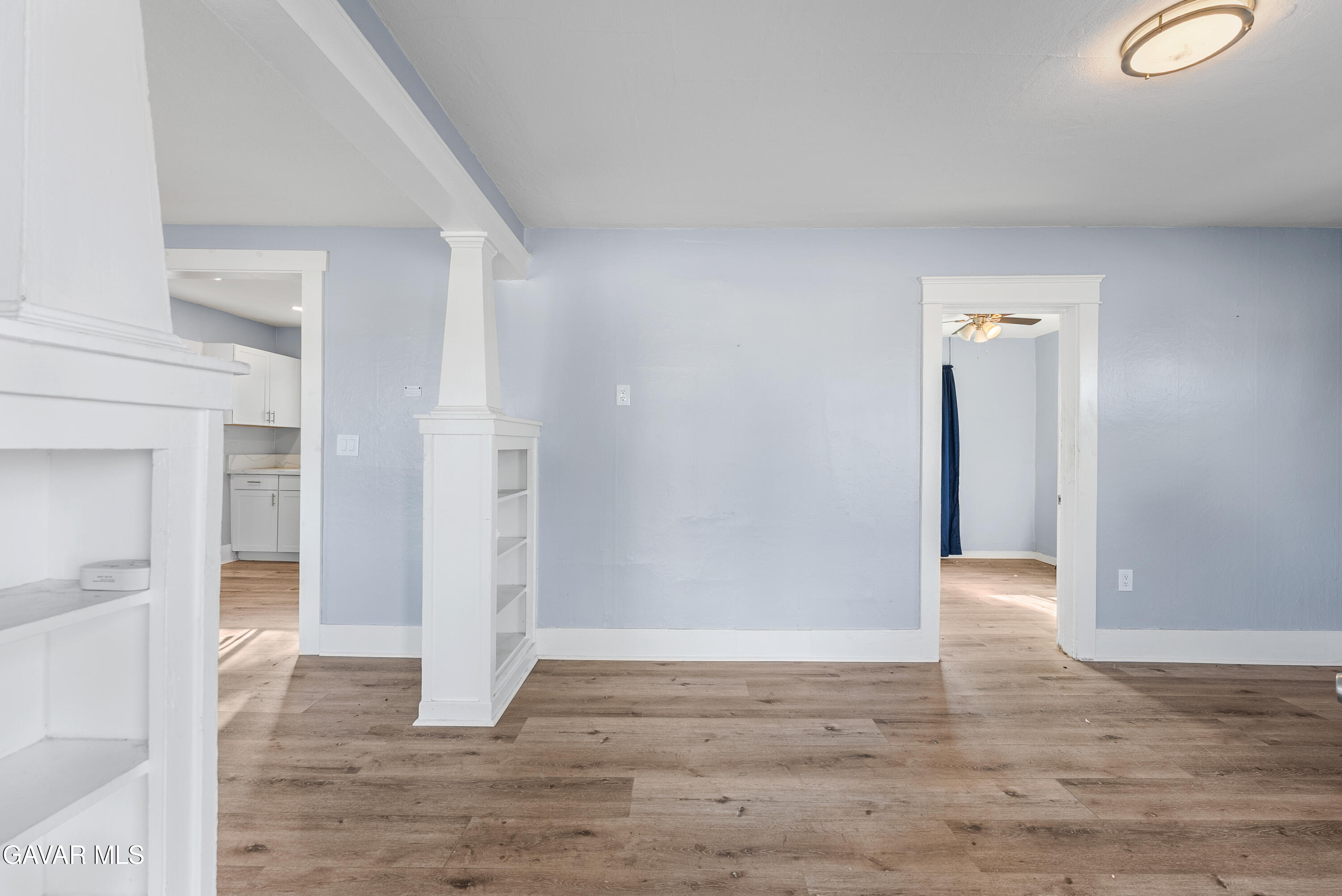 15733 K Street Mojave, CA 93501 - Photo 7 of 38 a view of an empty room with wooden floor and a bathroom
