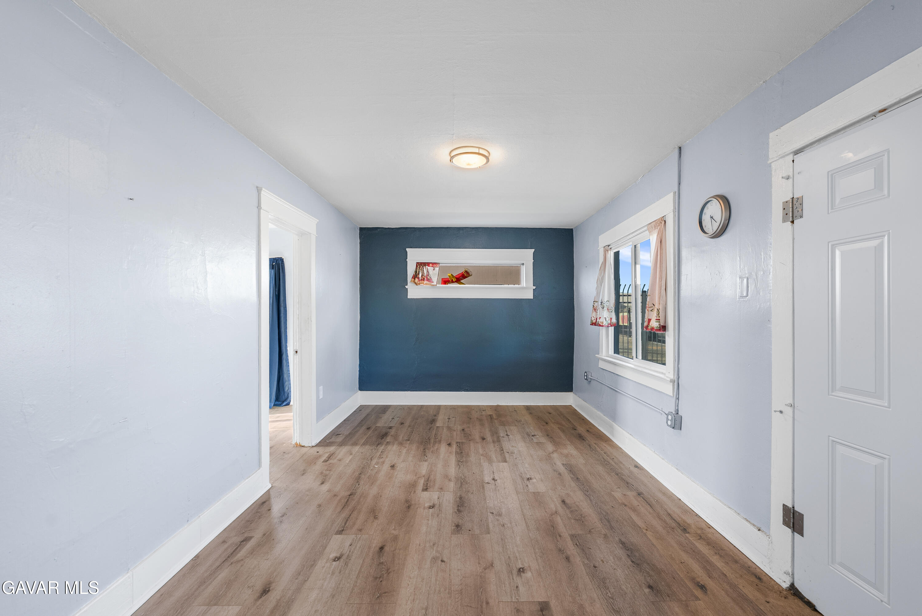 15733 K Street Mojave, CA 93501 - Photo 8 of 38 a view of a hallway with wooden floor and a living room