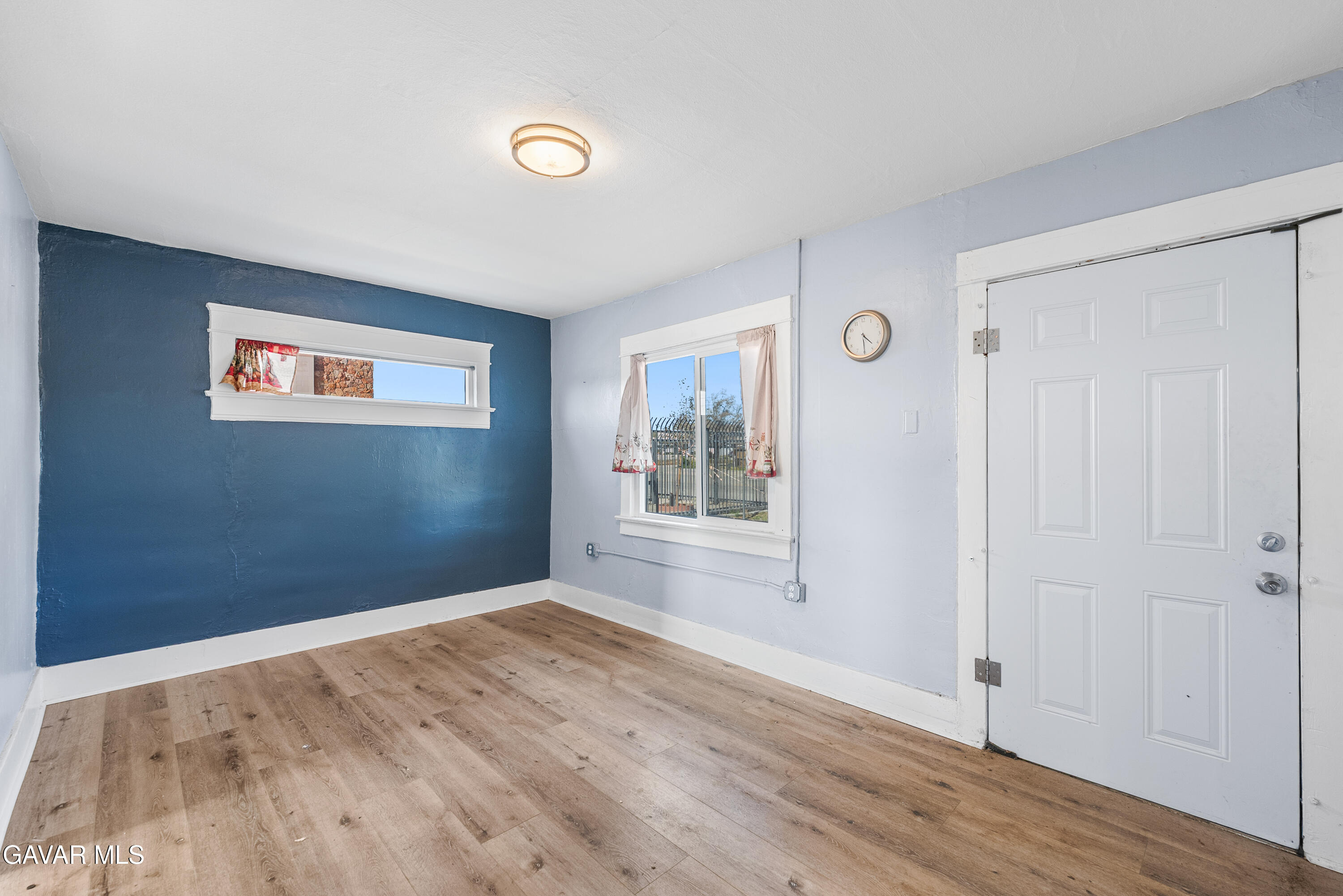 15733 K Street Mojave, CA 93501 - Photo 9 of 38 an empty room with wooden floor and windows