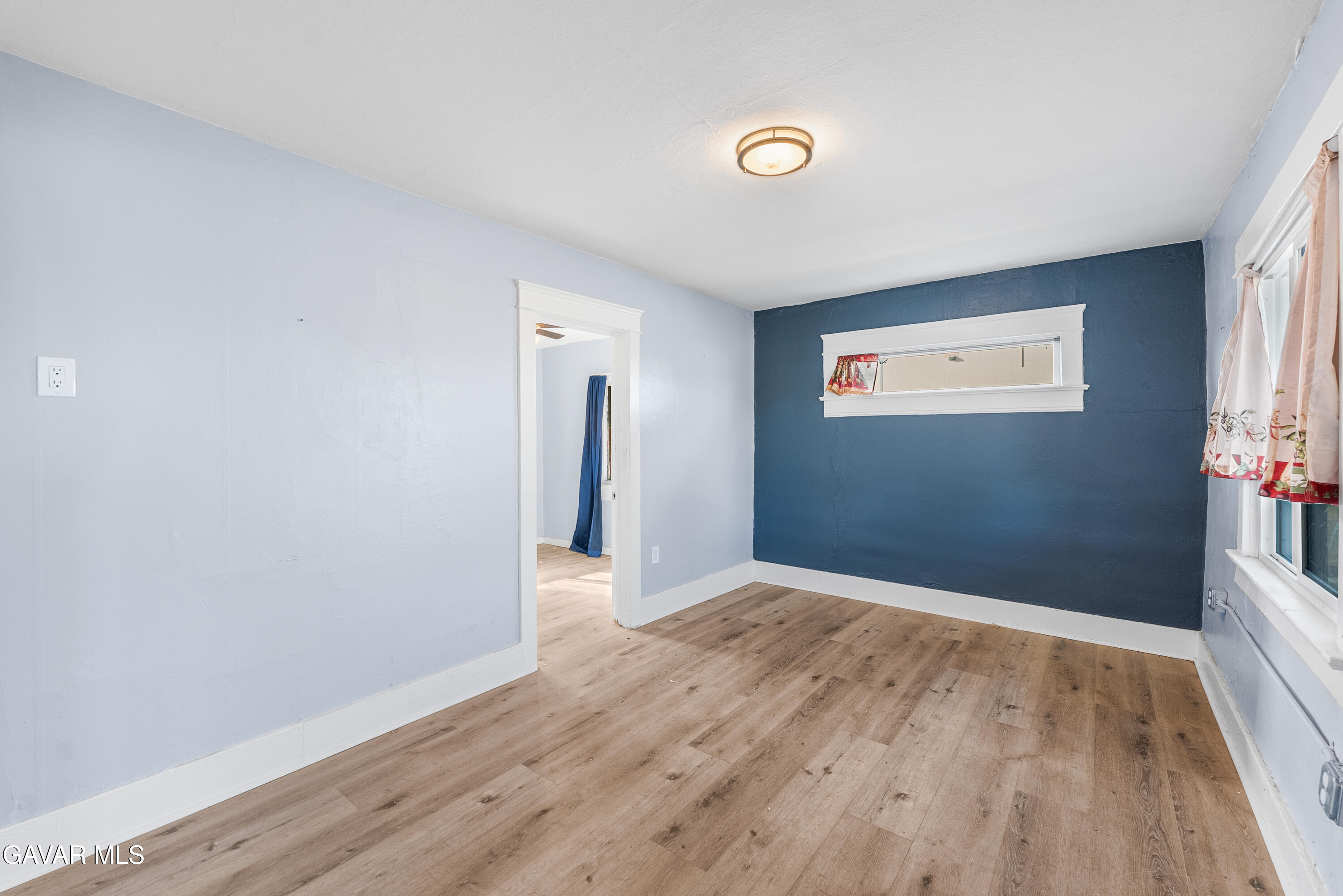 15733 K Street Mojave, CA 93501 - Photo 10 of 38 a view of an empty room with wooden floor and a window