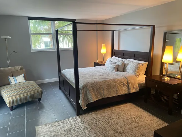 a bedroom with a bed and a couch