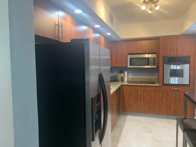 a kitchen with stainless steel appliances a refrigerator and a sink