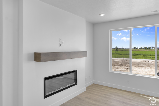 537 South 1150 West Logan, UT 84321 - Photo 5 of 33 Recessed lighting, wood-finish flooring, electric fireplace with floating mantel, and large picture windows