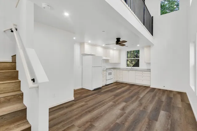 a kitchen with white cabinets and white appliances