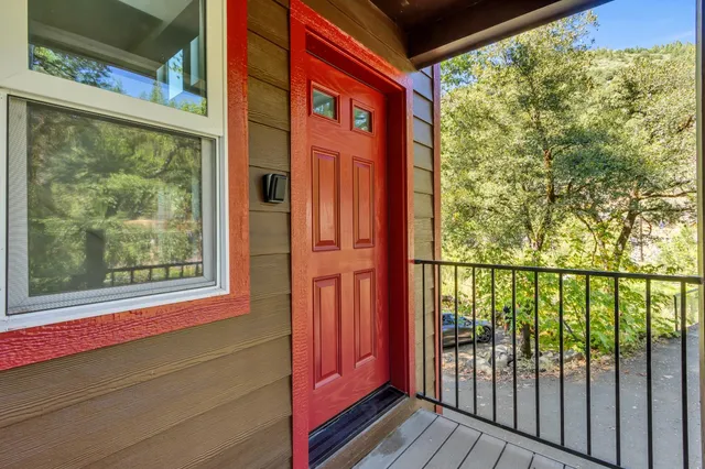 a view of empty room with wooden floor and window
