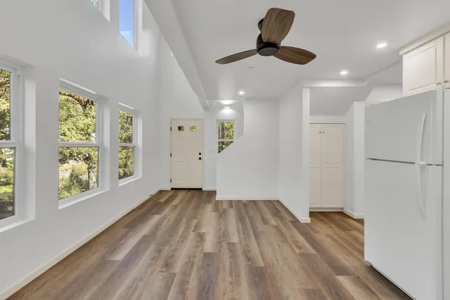 an empty room with a window and wooden floor