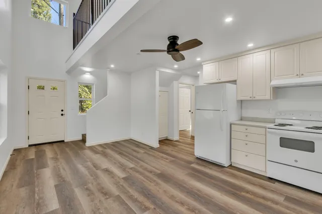 a view of a hallway with wooden floor