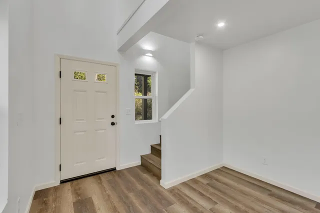 a view of a room with wooden floor and fan