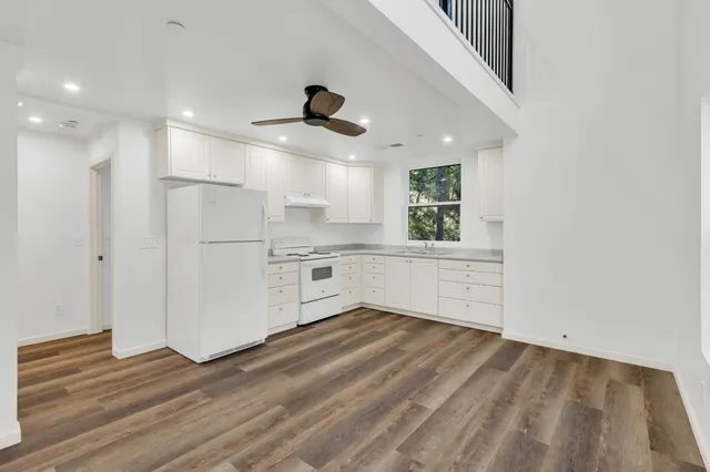 a kitchen with granite countertop a sink stainless steel appliances and cabinets