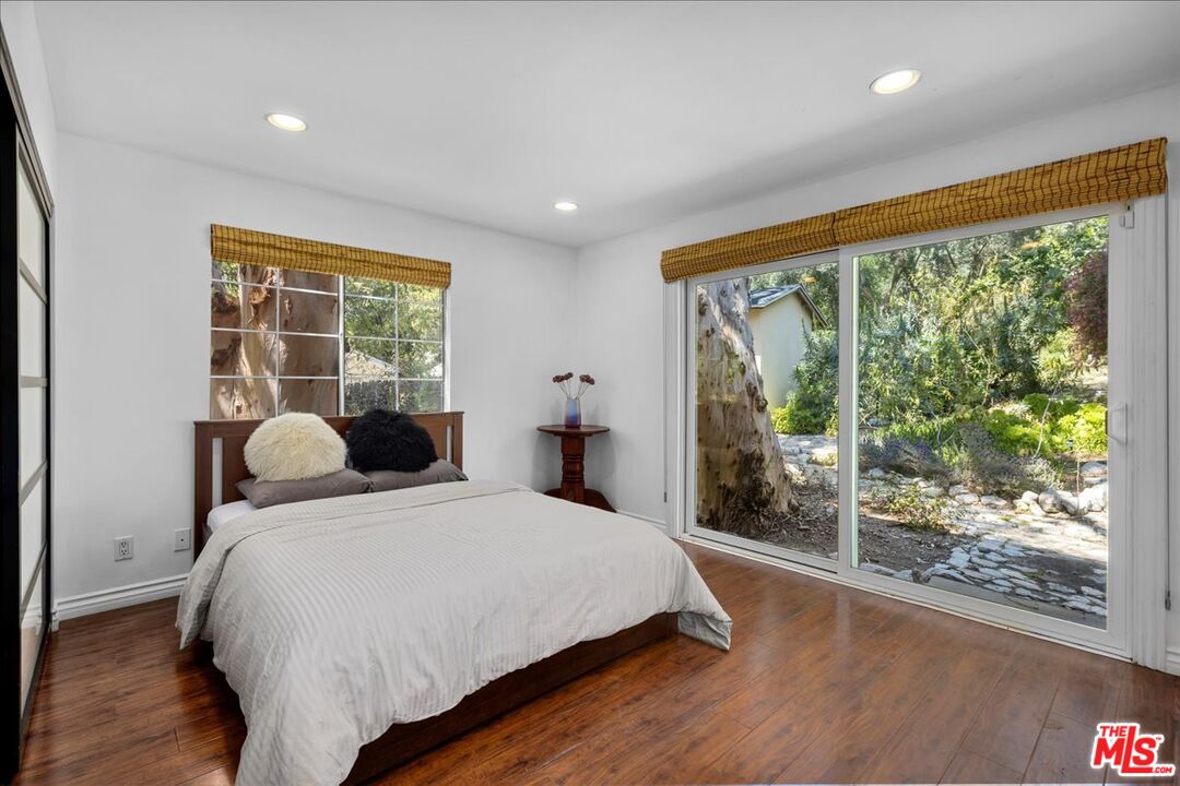 6867 Apperson Street Tujunga, CA 91042 - Photo 19 of 54 a bedroom with a large bed and a large window