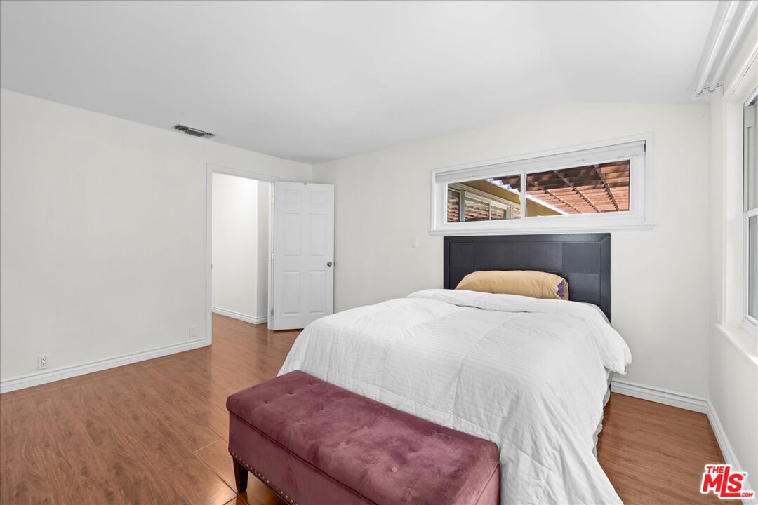 6867 Apperson Street Tujunga, CA 91042 - Photo 24 of 54 a bedroom with a bed and a table in it