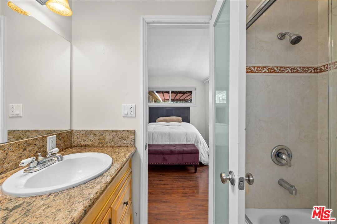 6867 Apperson Street Tujunga, CA 91042 - Photo 26 of 54 a en suite bathroom with a granite countertop sink and a mirror