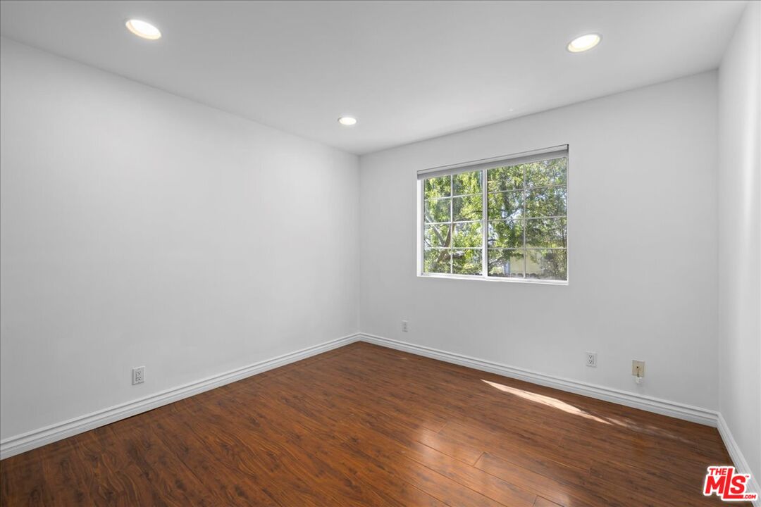 6867 Apperson Street Tujunga, CA 91042 - Photo 29 of 54 an empty room with wooden floor and windows
