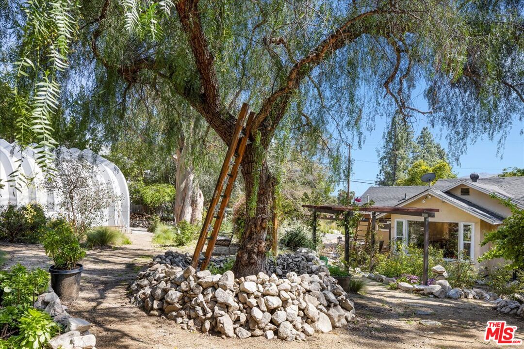 6867 Apperson Street Tujunga, CA 91042 - Photo 34 of 54 a front view of a house with a yard