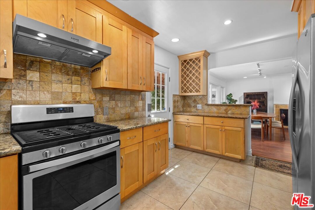 6867 Apperson Street Tujunga, CA 91042 - Photo 5 of 54 a kitchen with a stove a sink and cabinets