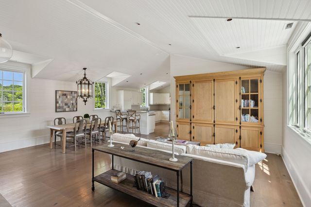 a living room with furniture a rug and a window