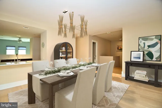 a living room with furniture chandelier and a flat screen tv
