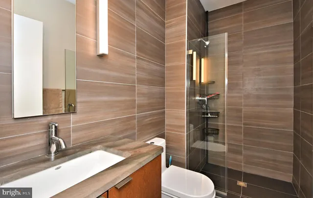 a bedroom with a bed and a ceiling fan