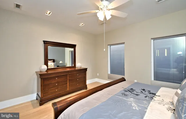 a bathroom with a granite countertop sink a mirror and a shower
