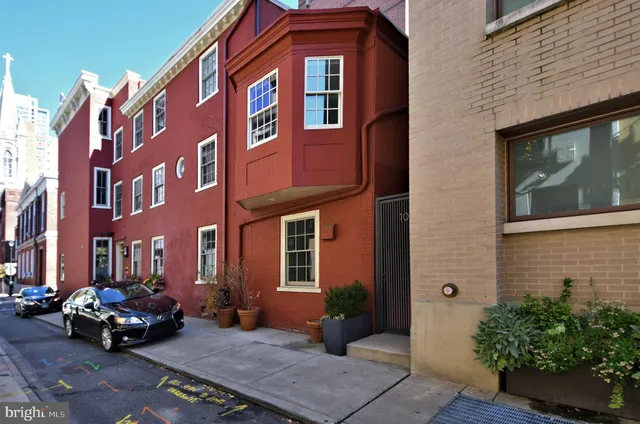 a car parked in front of a brick building