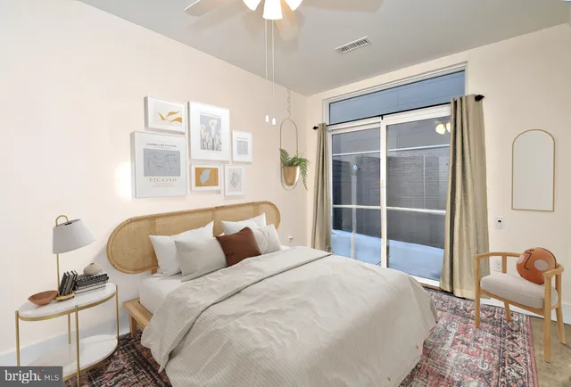 a bedroom with bed and wooden floor