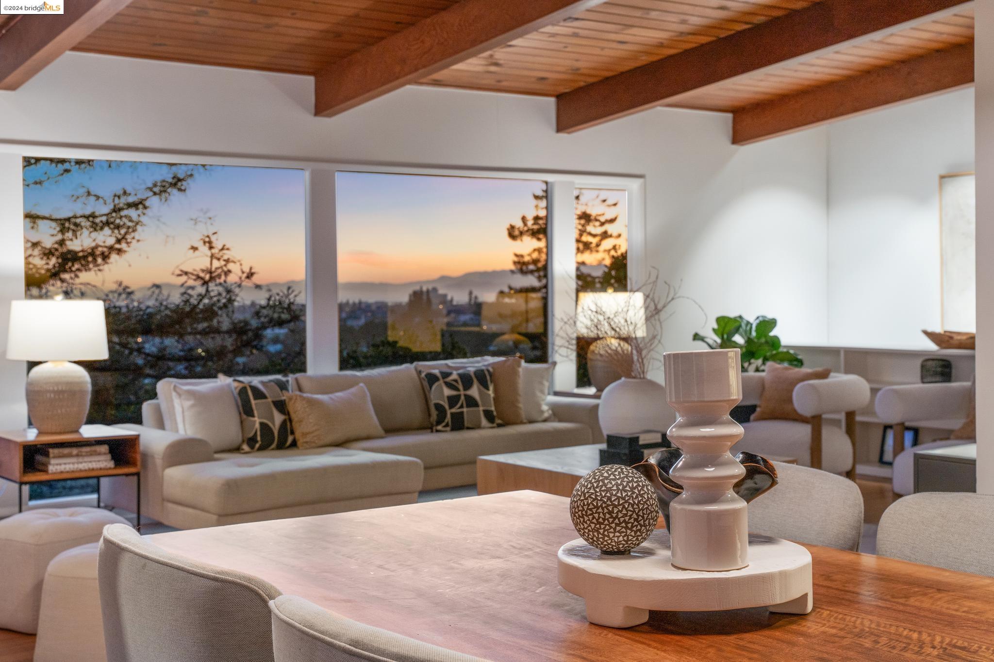 a living room with fireplace furniture and a large window