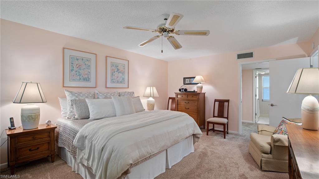 221 Quails Nest Road, Unit 4 Naples, FL 34112 - Photo 26 of 35 Master Bedroom looking towards ensuite bathroom and large walk-in closet.