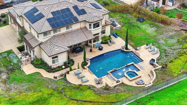a kitchen with kitchen island granite countertop a sink stove and cabinets