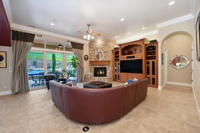 a kitchen with stainless steel appliances granite countertop a sink a stove and a wooden floors