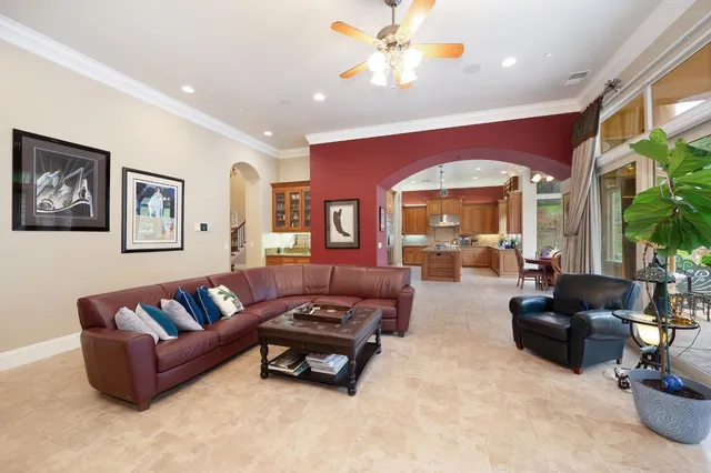 a bedroom with a bed a mirror and a fireplace