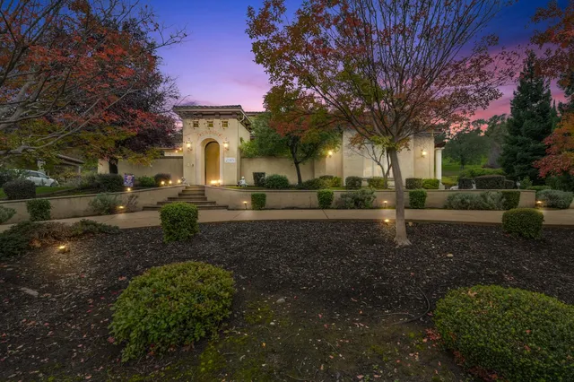 a view of entrance of the house with potted plants
