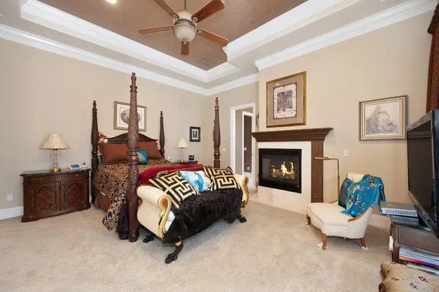 a large kitchen with a large counter space a sink stainless steel appliances and cabinets