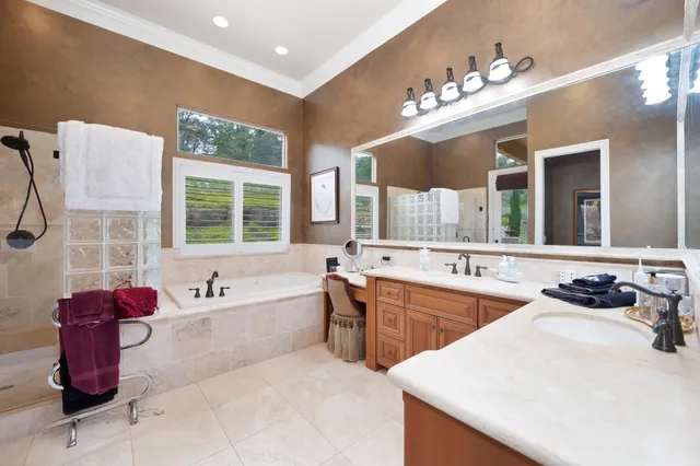 a spacious bathroom with a double vanity sink and a mirror