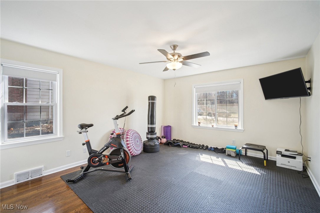 1445 Westover Road Cleveland, OH 44118 - Photo 21 of 47 First floor bedroom currently used as exercise room, including television and exercise mats over wood floor, and ceiling fan