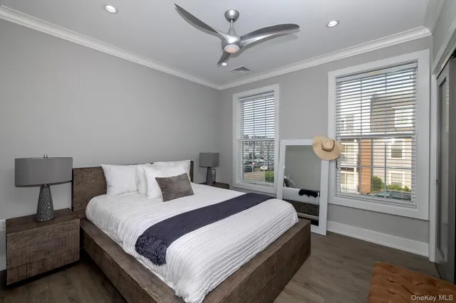 a bedroom with a bed and a large window