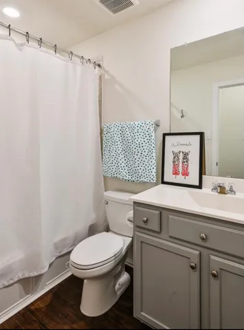 a bathroom with a toilet a sink and a mirror