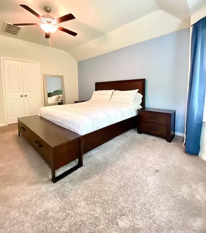 a bedroom with a bed and window