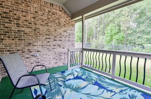 a balcony with table and chairs