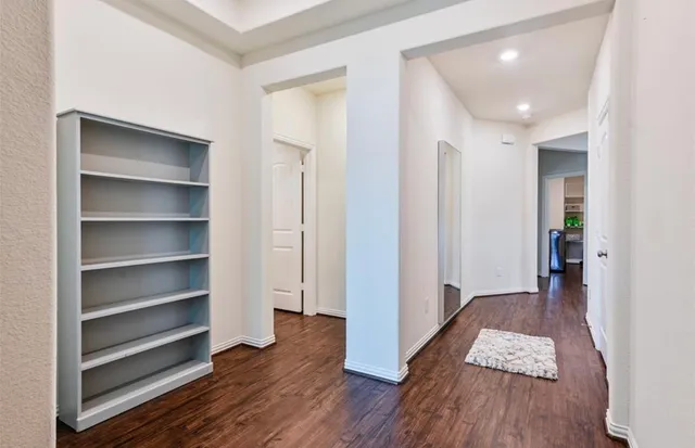 a view of wooden floor and closet in a room