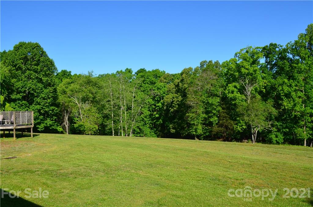 625 McEntire Road Tryon, NC 28782 - Photo 3 of 26 a view of a green field with wooden fence